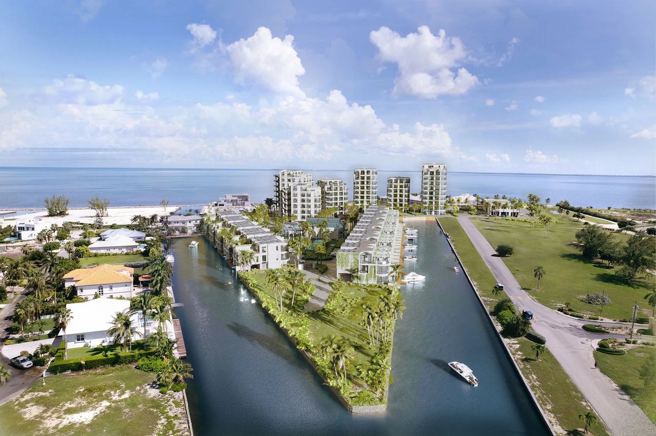 Canalfront hotel townhouses extend toward the Caribbean shoreline with private docks shown in a 3D visualization