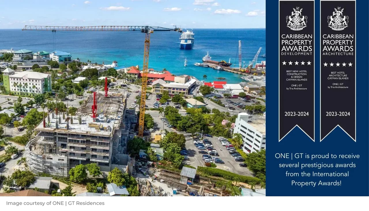 Photo of the One GT Hotel under construction on the Grand Cayman coastline with the Caribbean Sea nearby