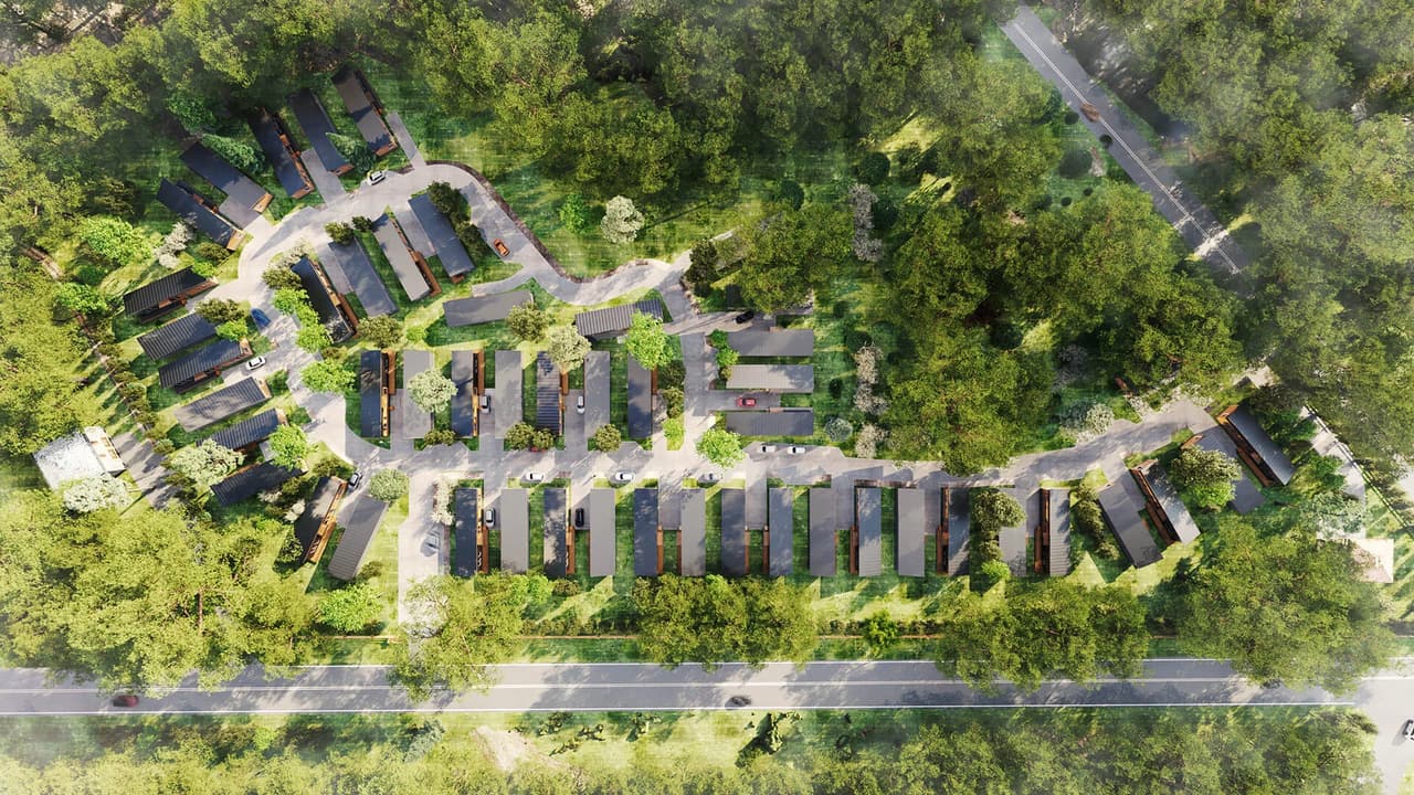 Aerial exterior 3D visualization of a townhouse masterplan winding through greenery