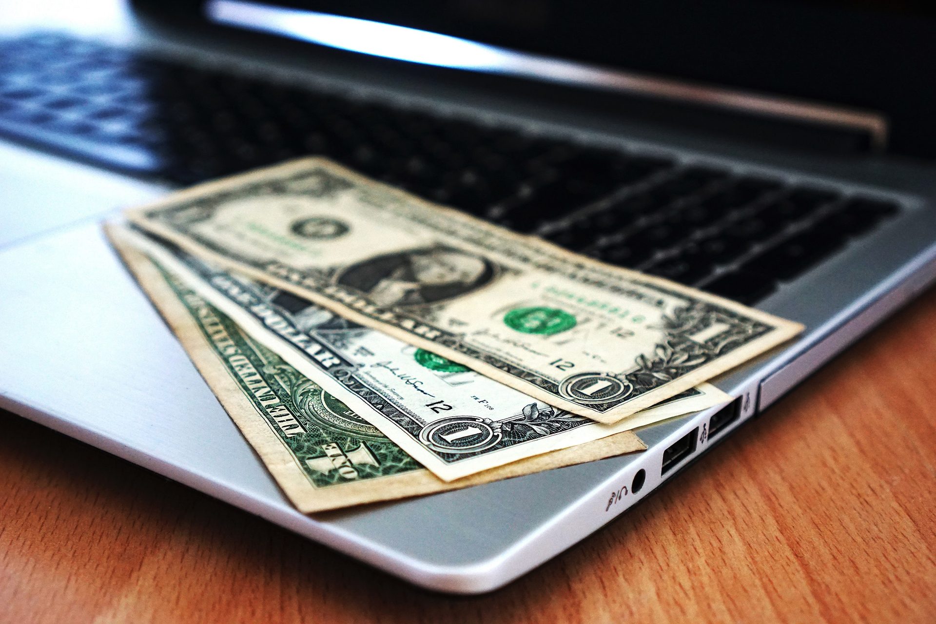 Dollar Bills on a Laptop of a CGI Studio's Client