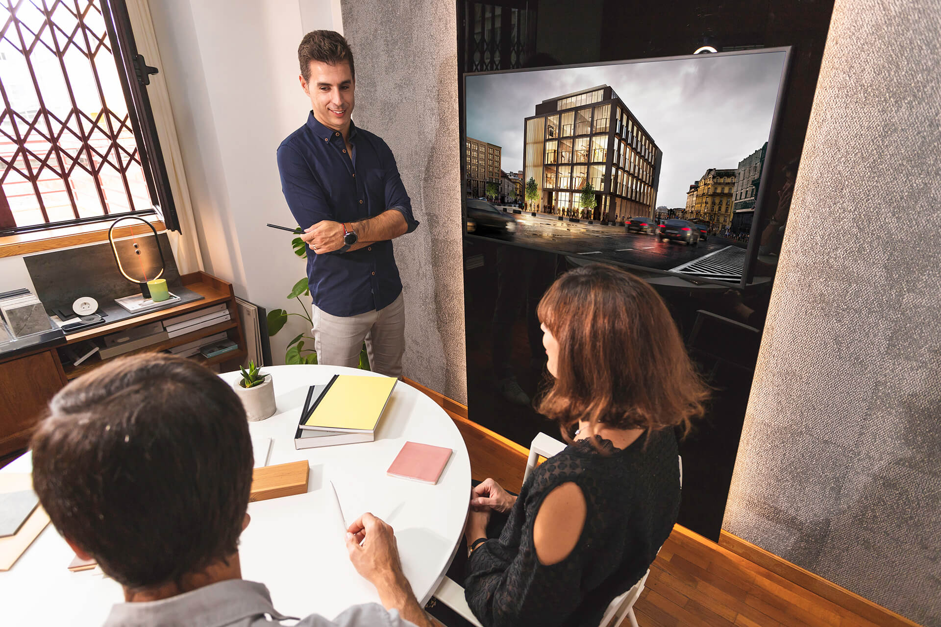 Architect Presenting His Design to Clients Using CGI