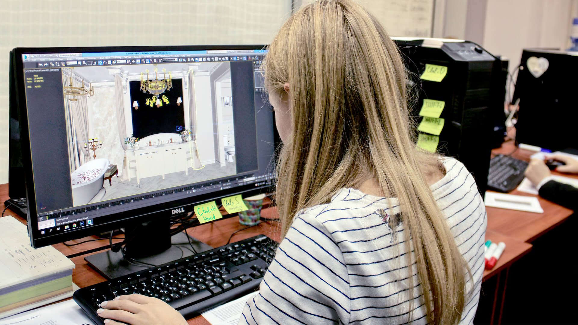 CGI artist working on an architectural rendering at a desktop computer