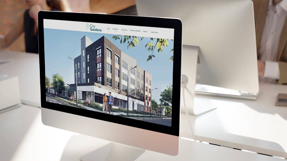 Real estate website design mockup shown on a laptop
