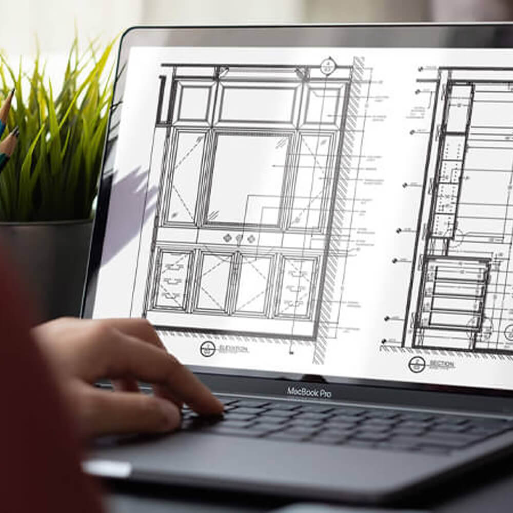 Drafting services image with an architectural floor plan on a laptop
