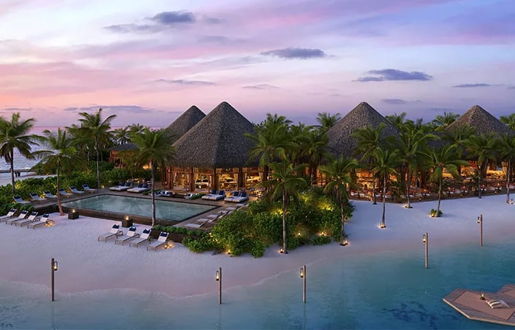 A tropical beachfront resort with thatched roofs, a pool, and palms presented in an architectural rendering