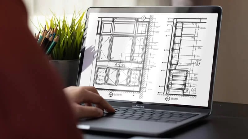 Millwork drawings for a Los Angeles interior project on a laptop