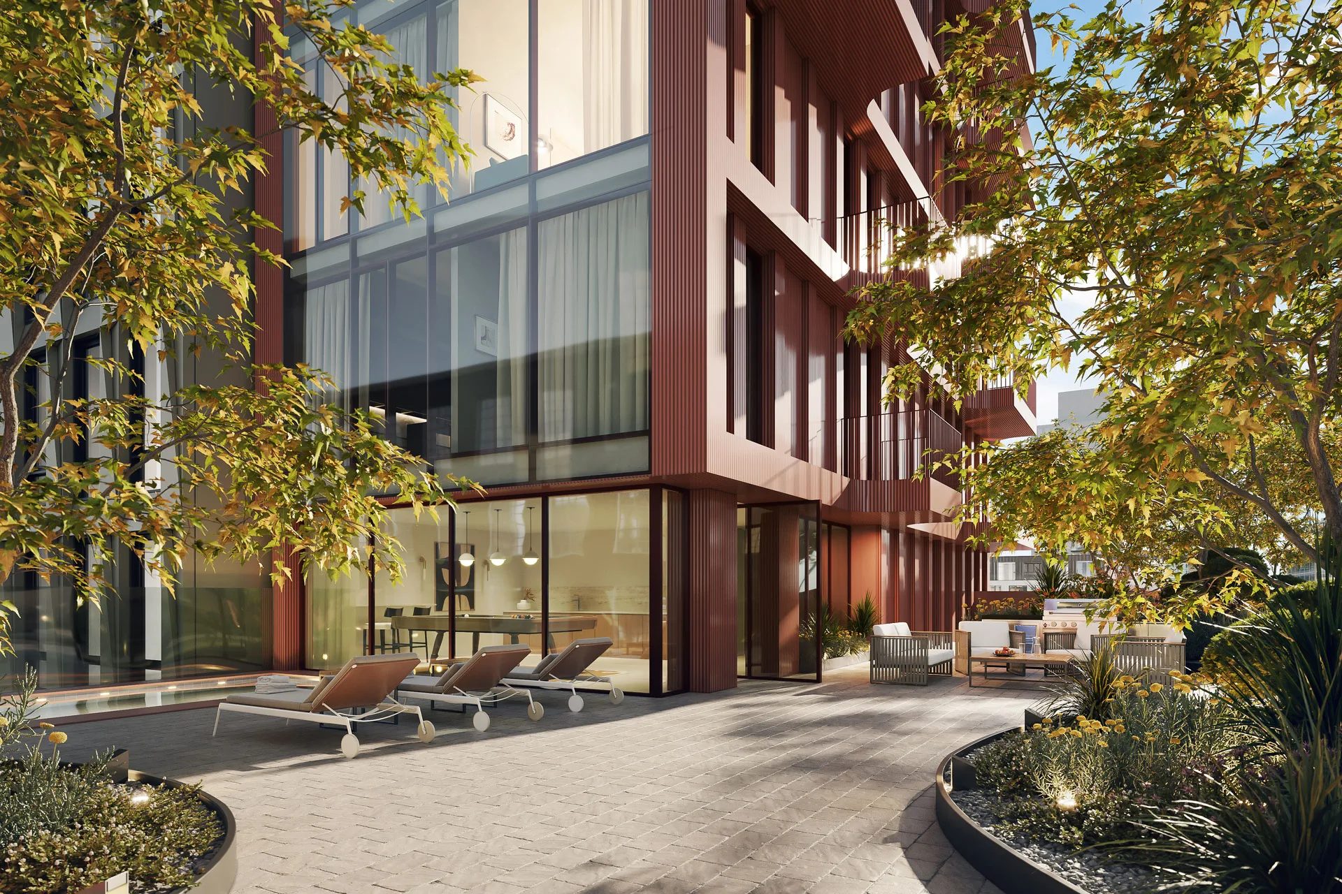 Outdoor amenity courtyard with pool, lounge chairs and floor-to-ceiling glass facade