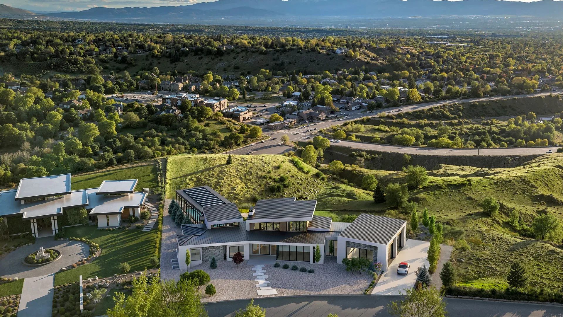 Aerial 3D photomontage render of a modern hillside estate overlooking a valley and distant mountains
