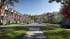 3D rendering of a tree-lined residential street with Tudor-style townhouses and blooming cherry trees in South Carolina
