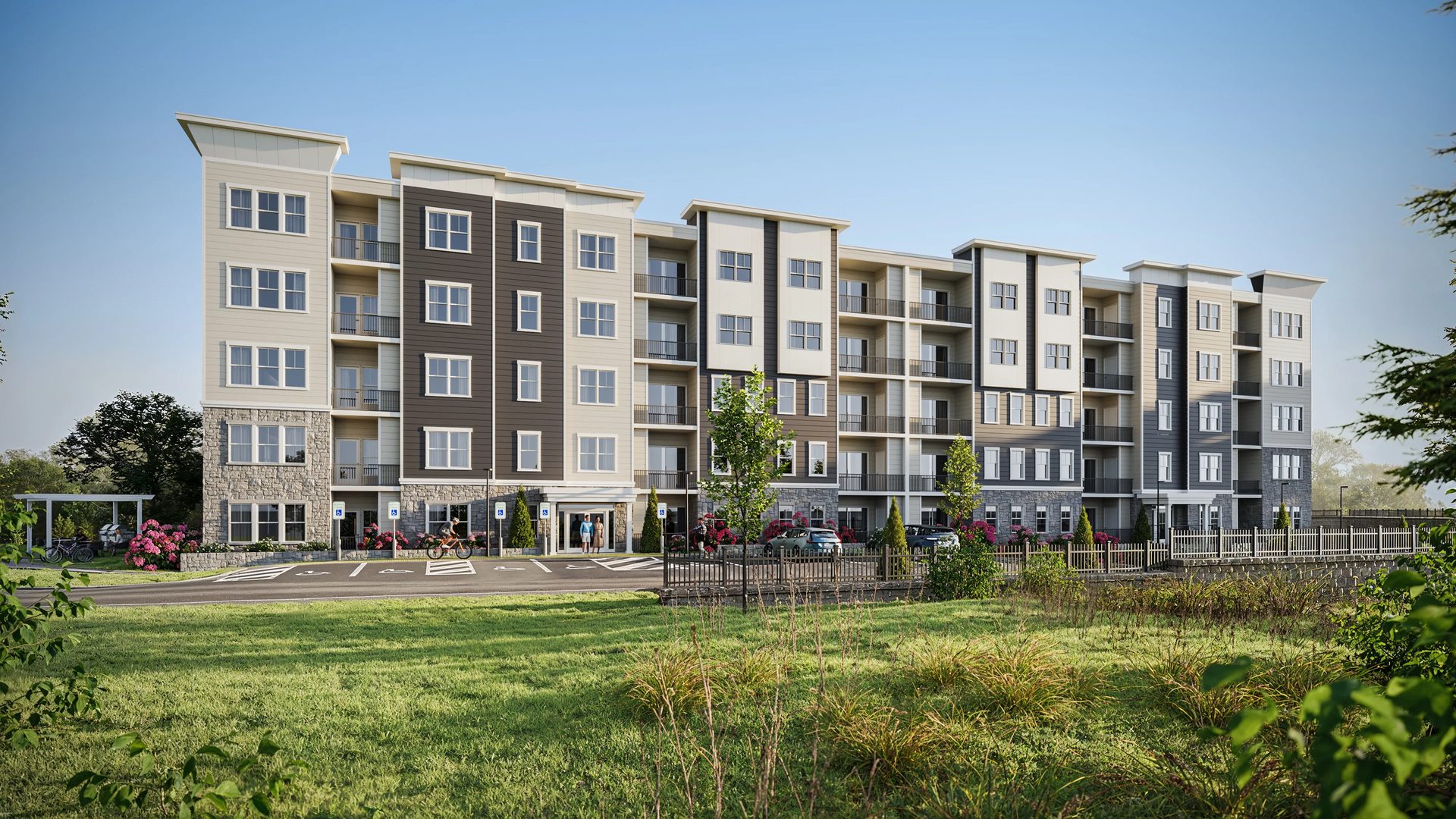 3D visualization of a five-story siding-and-stone apartment building with balconies, parking, and landscaped grounds in Massachusetts