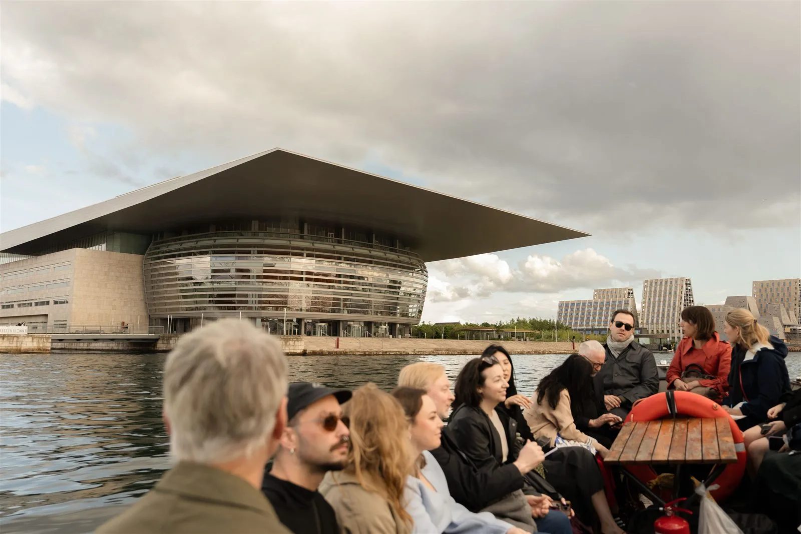 3daysofdesign guests on a boat in Copenhagen harbour with the Opera House behind