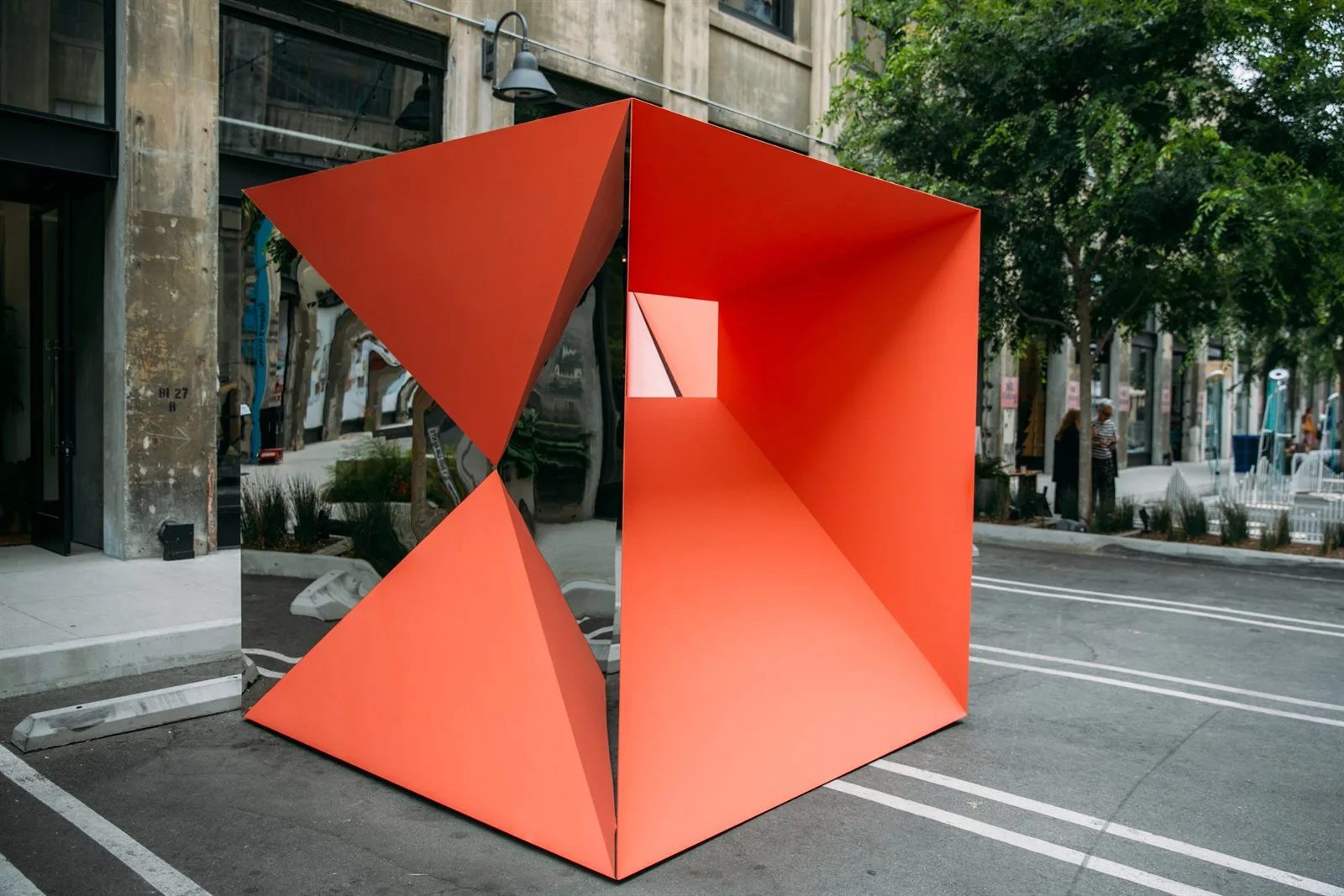 Orange folded-cube installation on a street in the Los Angeles Arts District during LA Design Festival