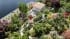 Aerial CGI view of a lakeside villa with a pink hip roof, pool terrace and lush landscaped garden along the Lake Como shoreline
