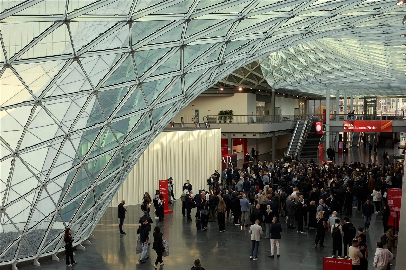 Visitors under the glass roof at the Fiera Milano Rho entrance during Salone del Mobile.Milano