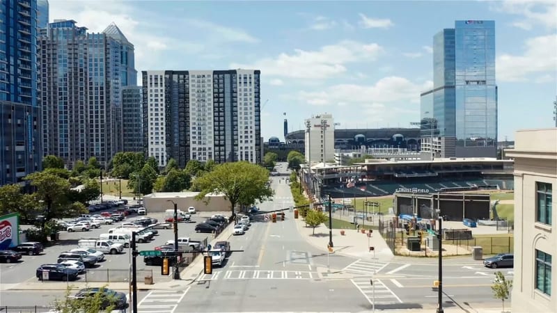 Aerial view rendering service: city street shown half as drone photo, half as CG