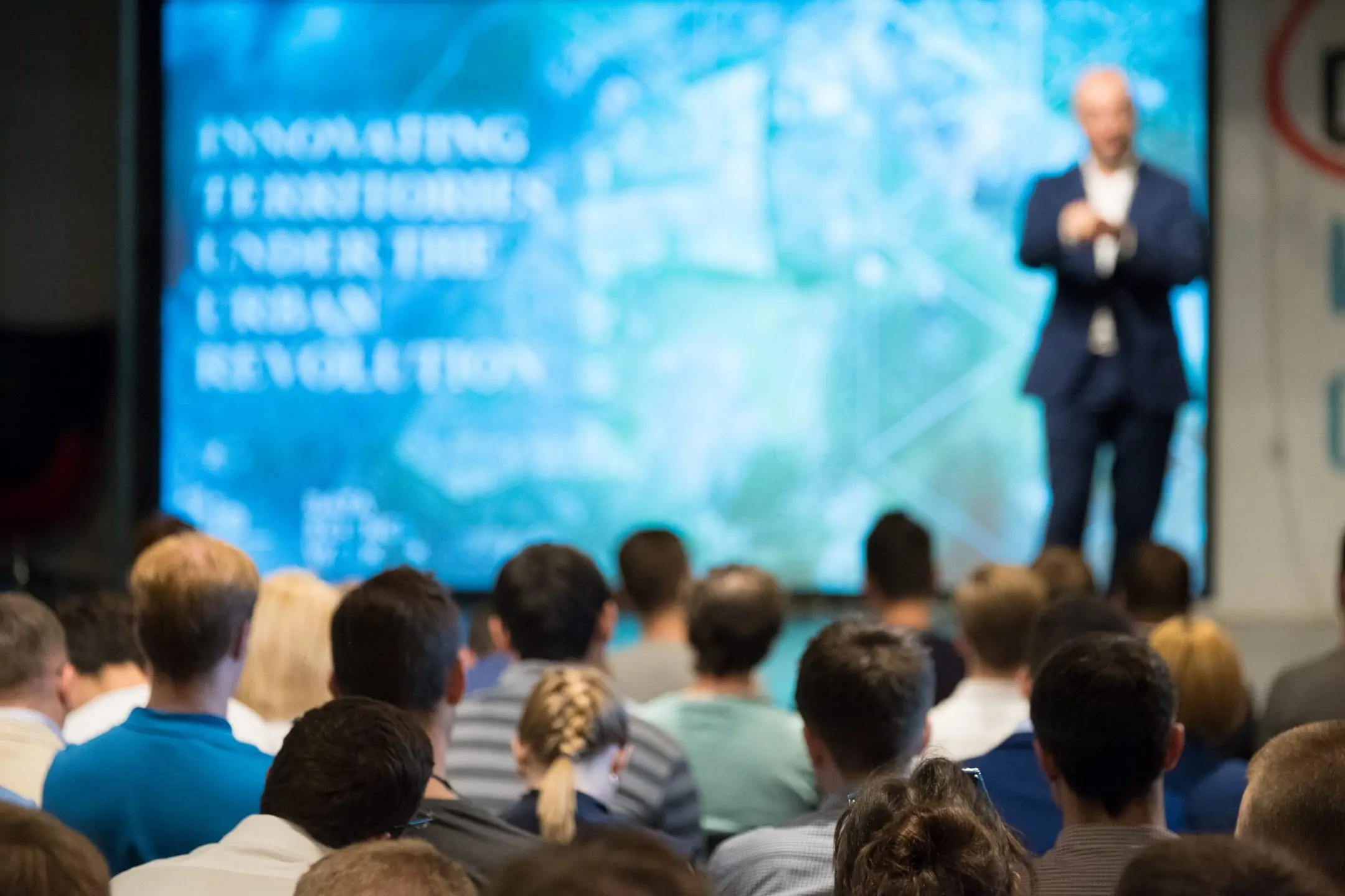 The Audience Listening to an Architect’s Speech at the Thematic Event