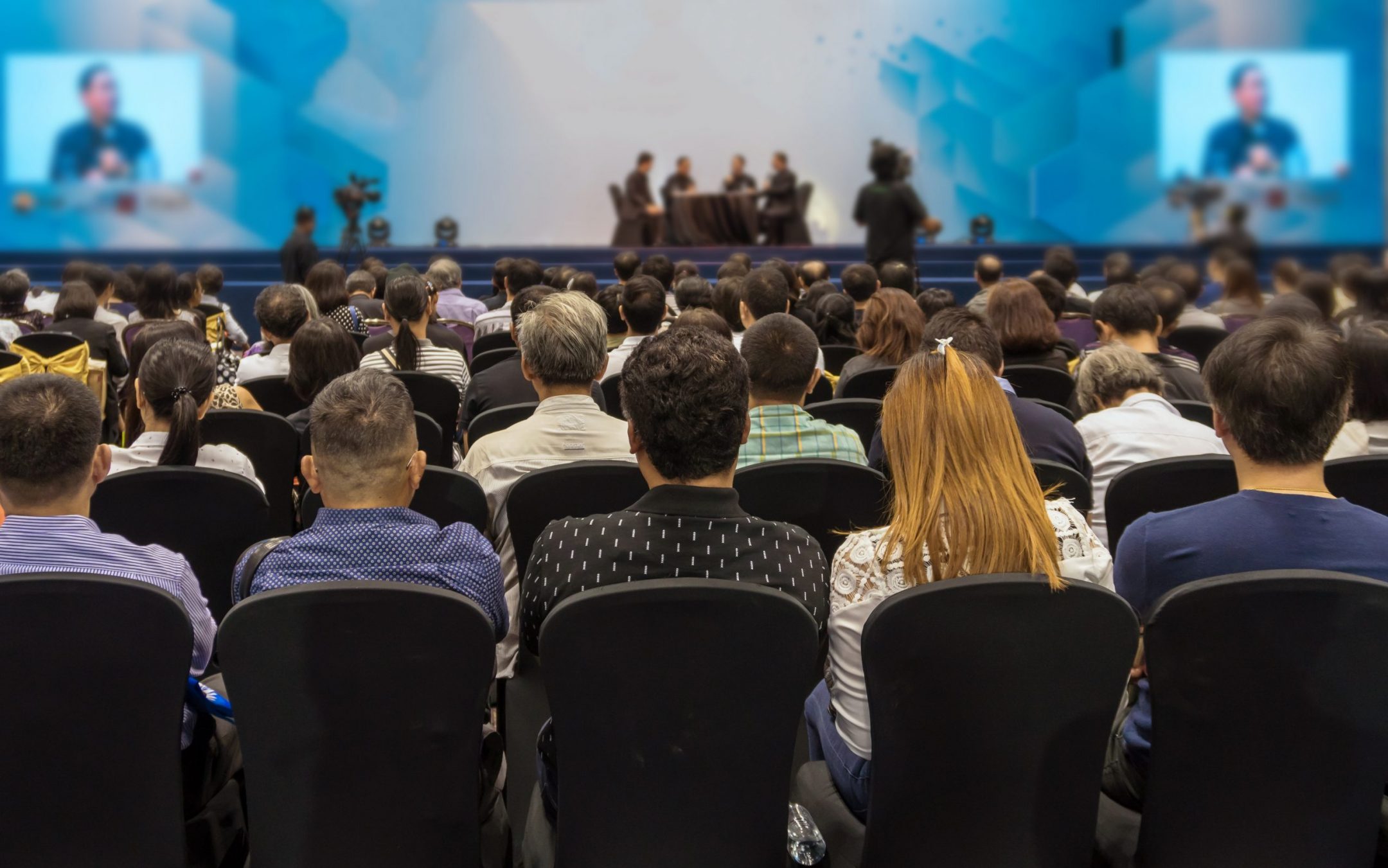 Visitors of an Architectural Event Watching a Presentation