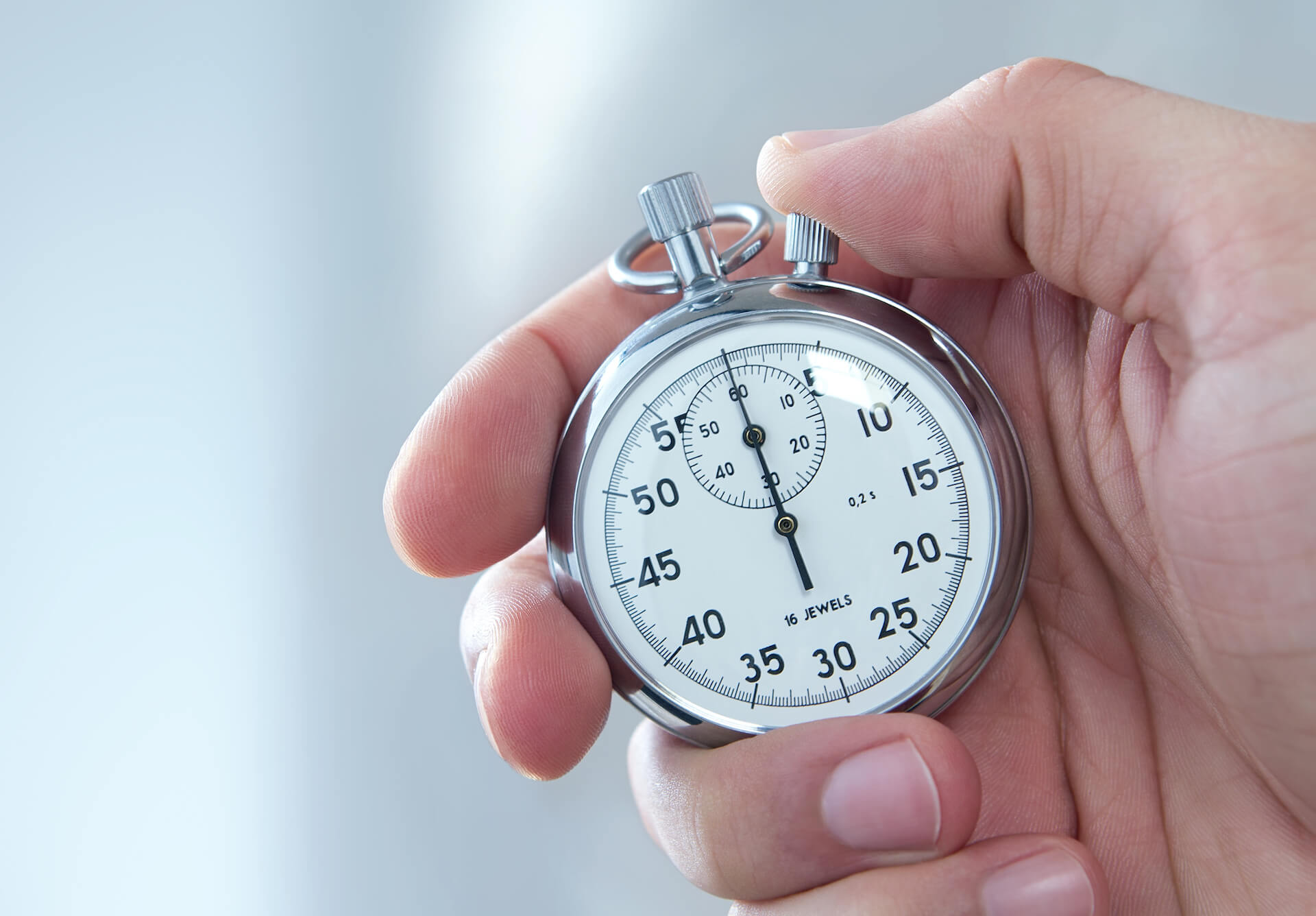 Hand Holding a Stopwatch