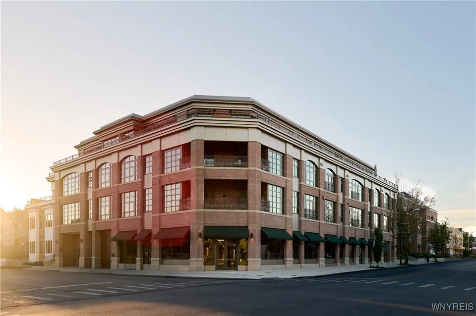 Photo of the finished project, a mixed-use brick building with street-level retail in New York