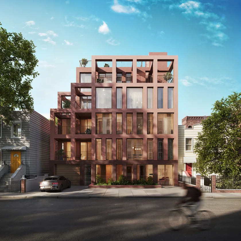Red brick building with upper floors set back and large windows on a city street in New York, Brooklyn